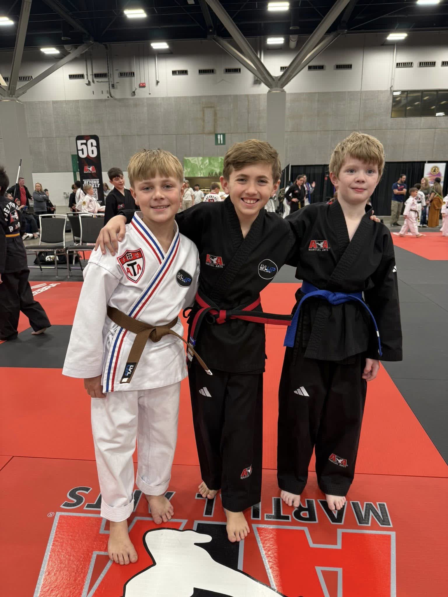 Instructor with student holding tournament medals